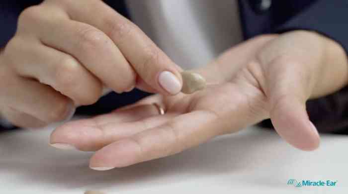 Miracle-Ear hearing aid shown in a hand