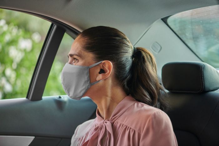 Woman in car wearing a mask