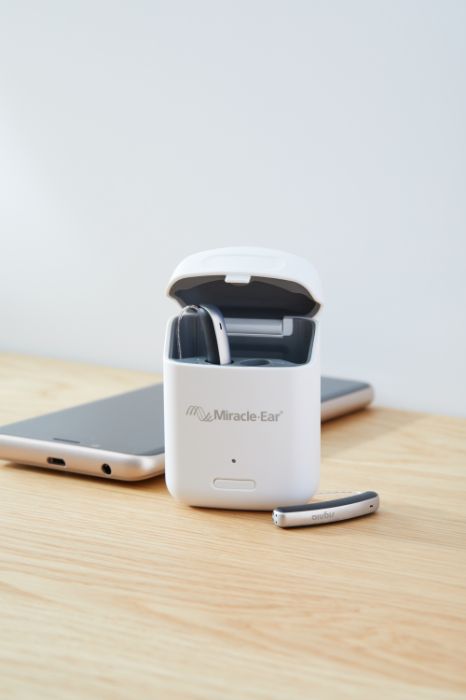 Rechargeable hearing aid in its charger