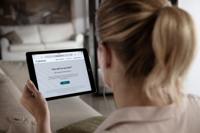 Woman taking the online hearing test