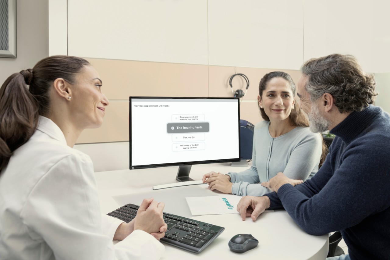 Customers checking hearing test results with audiologist