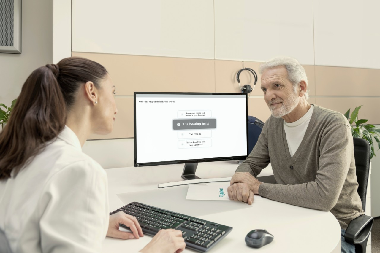 audiologist speaking with man