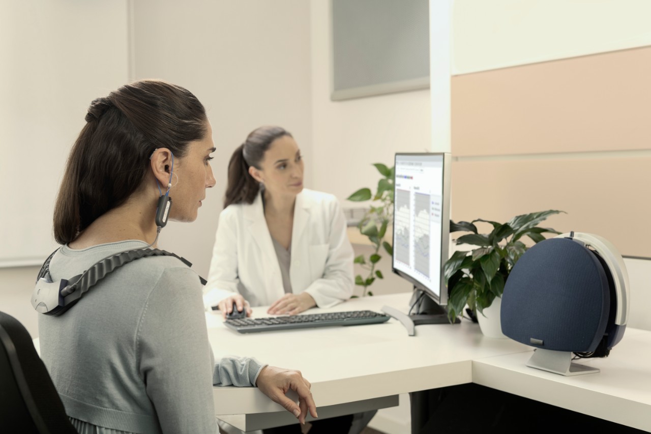 hearing instrument specialist working with patient