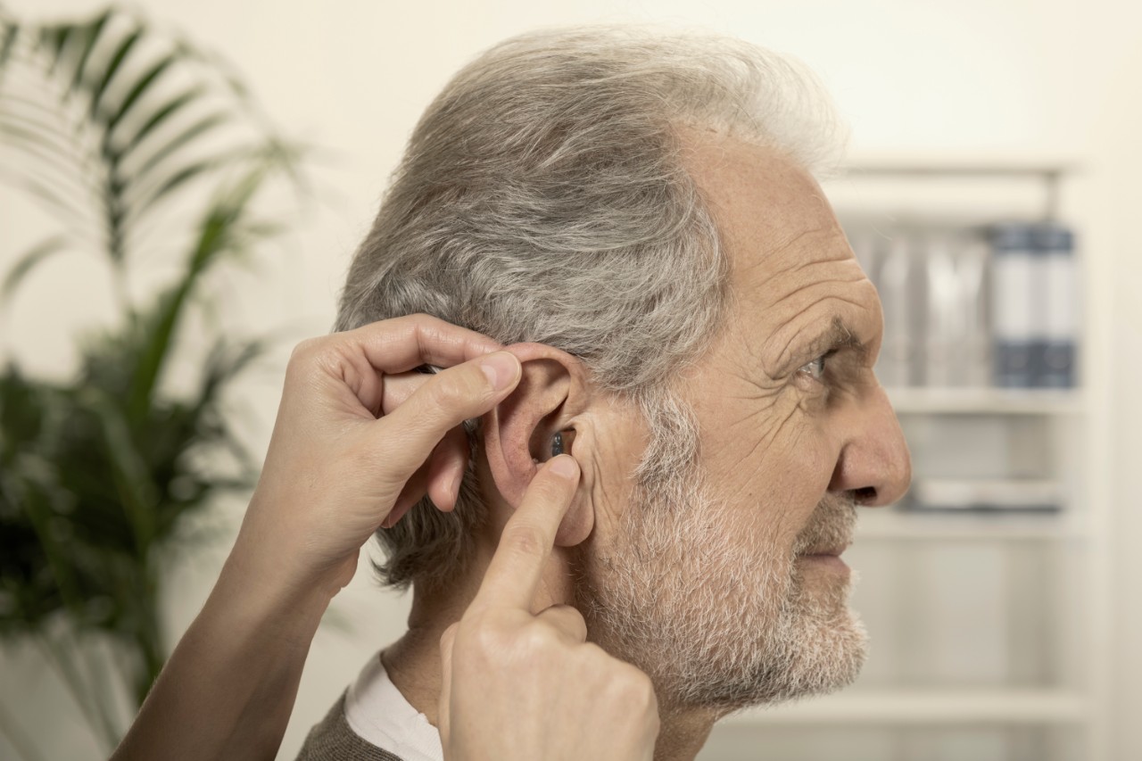 Profile of an elderly man with nearly invisible ITE hearing aids