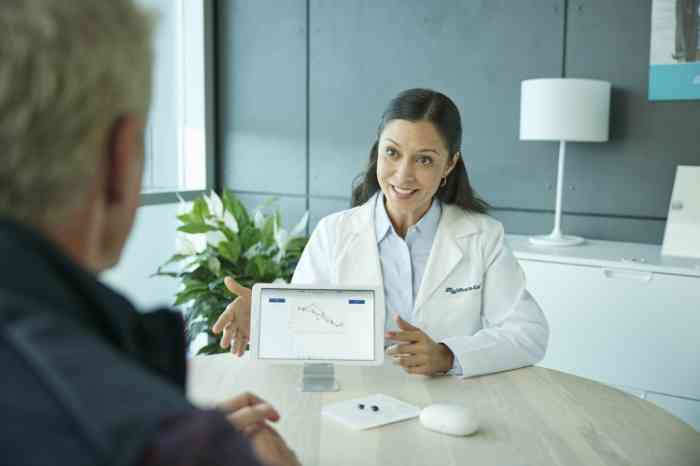 HCP at store showing to the patient hearing test results