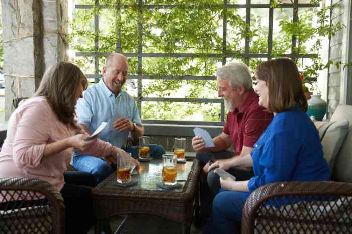 Miracle-Ear customers playing cards with their wives