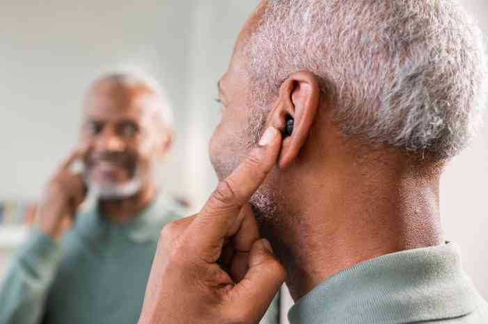man trying on miracle-ear mini hearing aids
