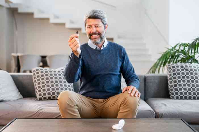 Man holding a hearing aid 