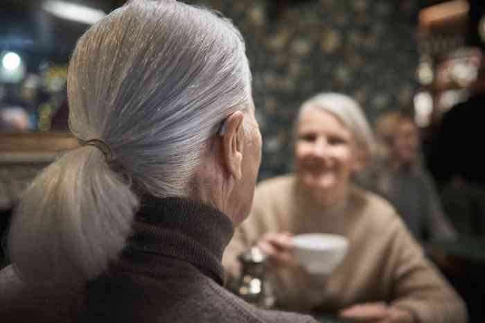 Two elderly women having tea together