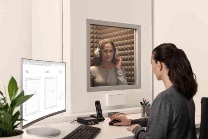A hearing professional conducting a hearing test