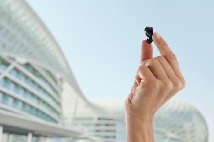 Hand showing a hearing aid