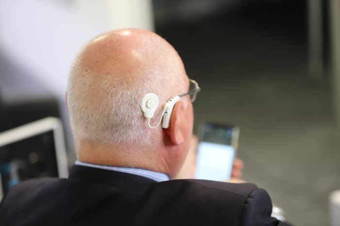 Old man with cochlear implant