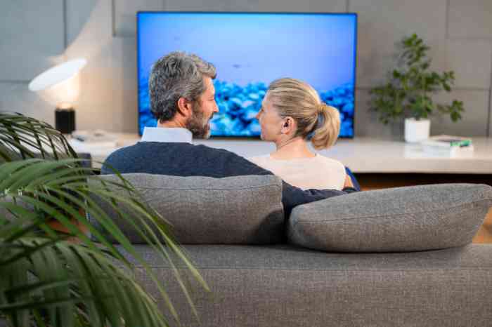 male and female on the sofa watching television