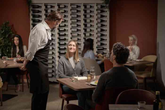 Waiter walking away from table with customers