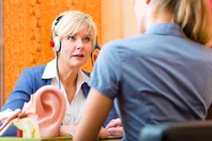 Woman taking a hearing test with an audiologist